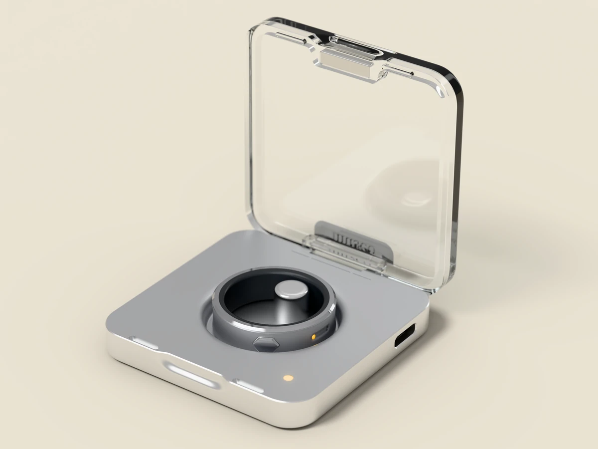 museo in natural, resting in its open clear lid charging case.